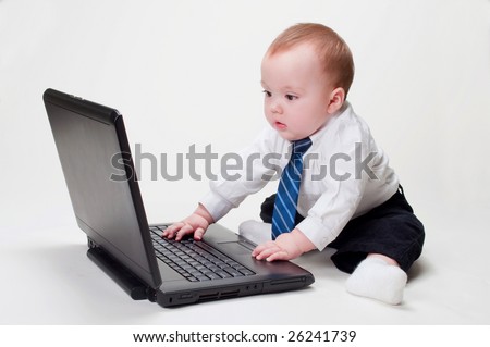 stock-photo-cute-baby-businessman-working-on-his-laptop-with-a-blank-screen-26241739.jpg