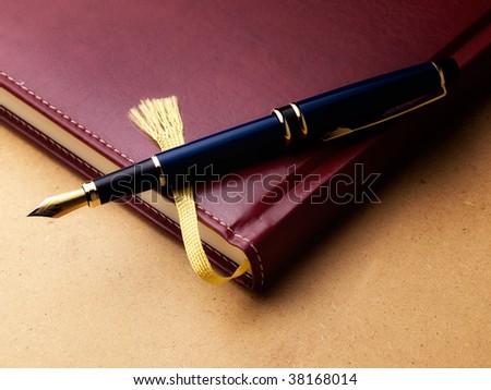 stock-photo-old-fashioned-diary-or-log-book-with-a-fountain-pen-on-a-grungy-background-38168014.jpg