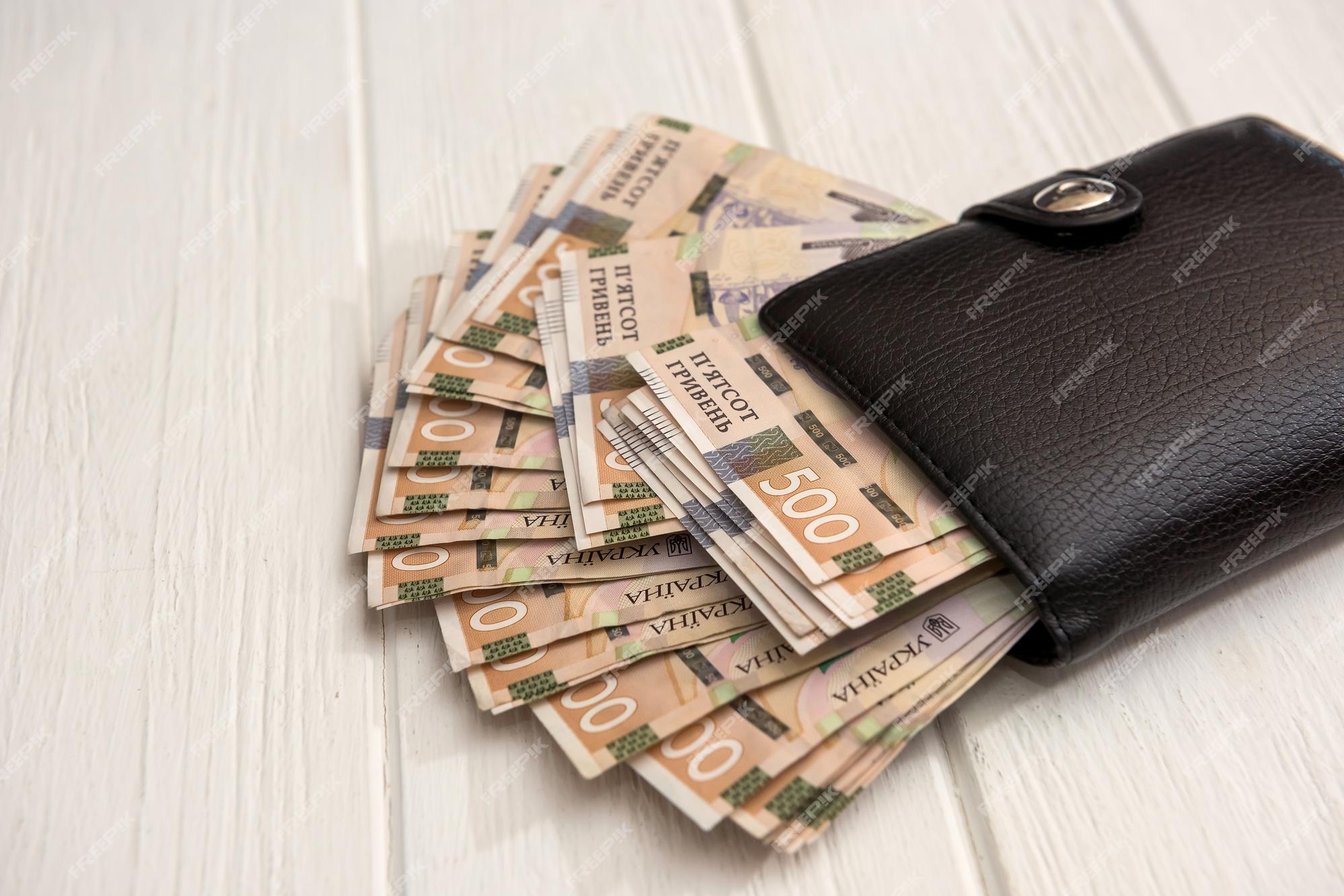 uah-black-men-s-wallet-is-full-money-uah-money-ukraine-1000-500-banknotes-desk-money-save-concept_359031-20670.jpg